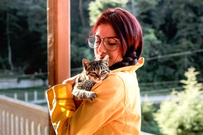 Young Woman Holding a Grey Cat